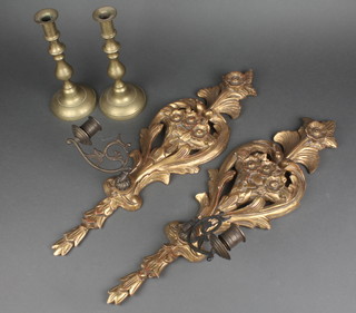 A pair of carved wooden and metal pierced wall sconces 22" together with a pair of brass candlesticks 9" 