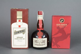 A 40cl bottle of Cointreau, a 70cl bottle of Grand Marnier and a 35cl bottle of Remy Martin cognac 