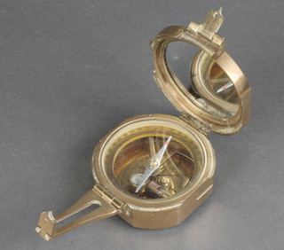 A reproduction brass prismatic compass 