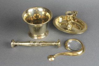 A 19th Century oval brass chamberstick, an 18th Century bell mortar and pestle, an Italian brass magnifying glass in the form of question mark 