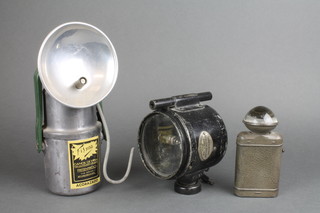 A Fisna carbide lamp, a Lucas signalling daylight lamp Mark 2 dated 1918 and a bullseye torch 