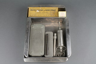 A field sterilising kit - boxed, a large glass syringe 20cc contained in a metal box, a small collection of medical instruments