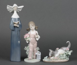 A Lladro figure of a standing girl with bird, bunch of flowers and watering can, base impressed 5217 7", a Lladro figure group of a cat and a frog, base impressed 4442 5", Lladro figure of a standing nun marked 1987 5500 10" (f)