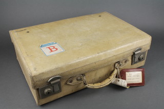 A white parchment suitcase with chrome mounts 6"h x 20"w x 13 1/2"d 