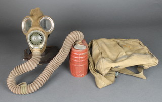 A WWII military issue respirator and canvas bag 