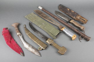 A Rodgers of Sheffield military issue knife, the 7" blade marked 27C/2360  complete with leather scabbard, a Martindale machette, an Eastern dagger with 9 1/2" blade and brass scabbard, a reproduction Kukri with 9 1/2" blade and a swagger stick 