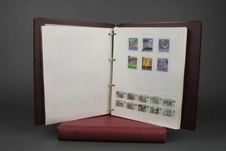 A Stanley Gibbons album of New Zealand mint stamps, volume 2 1991 onwards together with a red album of New Zealand used stamps 