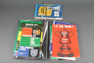 A box of various Cup Final and Semi-Final programmes