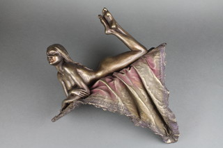 A bronzed figure of a reclining naked lady on rug 16" x 15" 