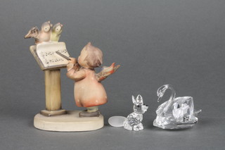 A Goebel figure of a standing girl with lectern and birds 3 1/2", a Swarovski figure of a seated fox 1 1/2", do. swan 2" 