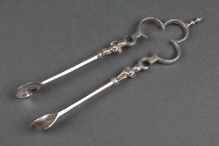 A pair of Victorian silver sugar nips with cherub stems London 1878