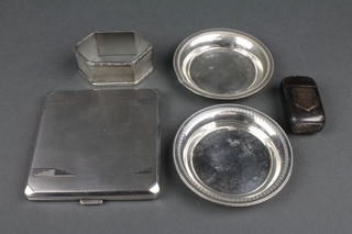 An Art Deco silver engine turned cigarette case, a napkin ring, 2 nut dishes and a plated vesta
