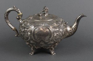 A Victorian melon shaped repousse silver teapot, raised on scroll legs,  Sheffield 1862, maker John Harrison & Co, approx. 76.4 grams