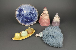 A Carlton Ware 4 piece condiment set comprising tray in the form of a banana and cruet in the form of an orange, apple and lemon, a pottery plate decorated a moonlit landscape 9", a 1930's porcelain tea cosy finial, 2 1930's pottery figures of crinoline ladies 7" and 5"  

