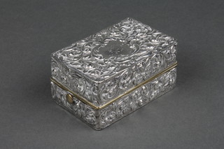 A repousse silver toilet box with scrolls and floral decoration