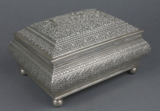 A Thai white metal rectangular baluster casket decorated with stylised figures on a floral ground on ball feet, approx 1130 grams 