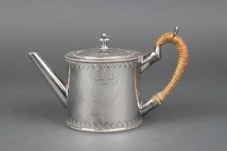 A 19th Century silver plated teapot of plain form with lappet  decoration and cane handle 
