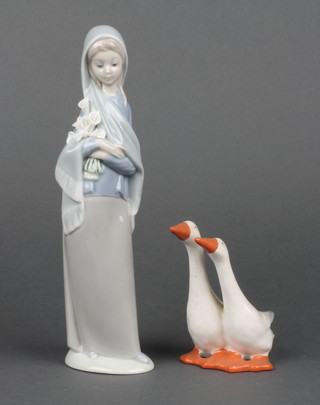 A Beswick figure group of 2 standing geese 4" and a Lladro figure of a lady with bunch of lilies 9" 