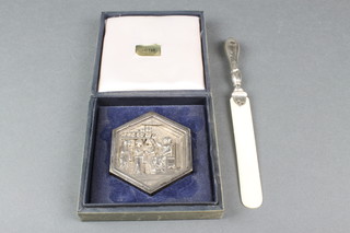 A Continental silver hexagonal commemorative paperweight, 116 grams and a silver mounted paper knife