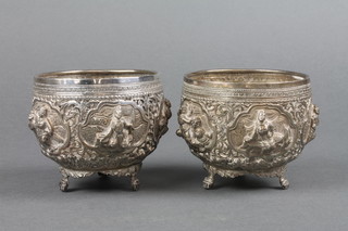 A pair of repousse Indian silver bowls decorated with figures, on stylised claw feet, approx 272 grams 