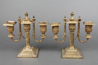 A pair of 19th Century Adam style 2 light gilt candlesticks with spiral stems and acanthus swags on stepped bases 