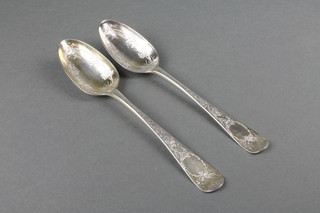 A pair of Georgian silver chased berry spoons, gross 138 grams