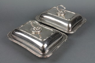 A pair of silver plated entree sets