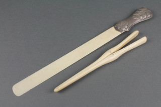 An Edwardian repousse silver handled paper knife with acanthus decoration, a pair of bone glove stretchers