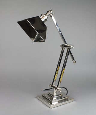 A silver plated articulated student's desk lamp with stepped base 