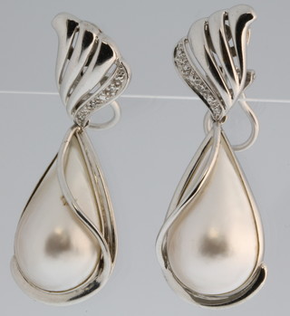 A pair of 9ct white gold diamond set and pearl drop ear clips