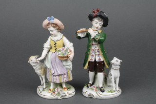 A pair of 19th/20th Century Continental porcelain figures of standing boy flutist with dog and shepherdess with basket of flowers, base with crowned S mark, 6"h 