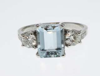 An 18ct white gold aquamarine and diamond ring, the centre aquamarine approx. 2ct flanked by 2 brilliant cut diamonds approx. 0.6ct, size N 1/2