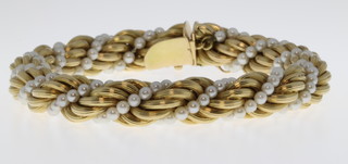 An 18ct yellow gold and seed pearl entwined bracelet, gross 38 grams 