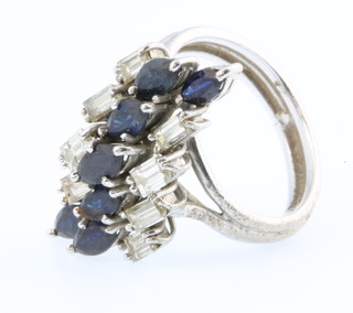 An 18ct sapphire and diamond up finger ring, size G