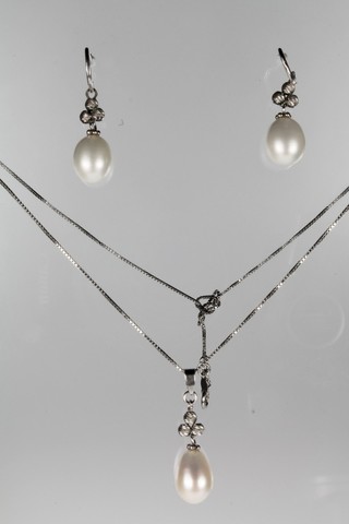 A pair of silver and pearl drop earrings and a ditto necklace