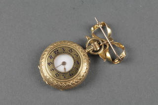 A lady's 18ct engine turned half hunter fob watch on a 15ct gold ribbon pin 