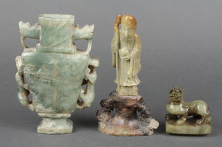 A carved soapstone figure of a deity on a raised base 6" and a ditto flattened vase with stylised lion finials, a carving of a shi shi