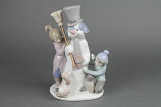A Lladro group of 2 figures and a puppy before a snowman no.5713 9" 