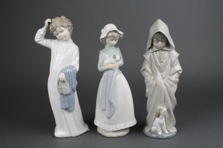 A Nao figure of a child with a puppy 10" and 2 others 