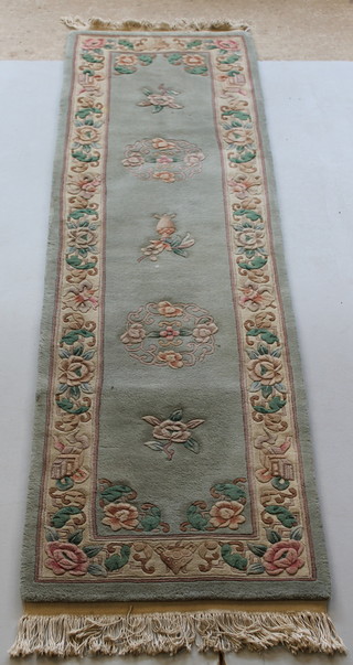 A green ground and floral patterned Chinese runner 97" x 27 1/2" 