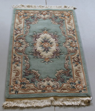 A green ground and floral patterned Chinese rug 63" x 36" 