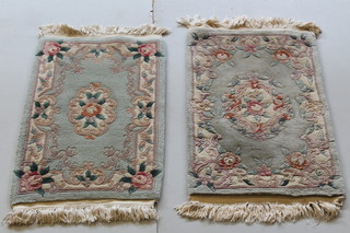 2 similar green ground and floral pattern Chinese rugs 38 1/2" x 22 1/2" and 36 1/2" x 24 1/2" 