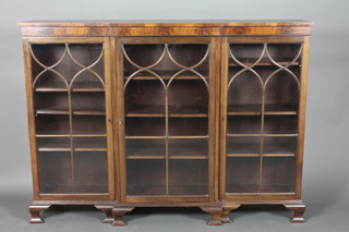 A Georgian style mahogany triple breakfront bookcase, the interior fitted adjustable shelves enclosed by astragal glazed doors and raised on ogee bracket feet 44"h x 60"w x 12 1/2"d 