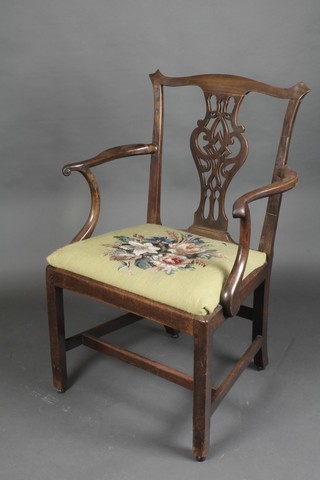 A Georgian Chippendale style mahogany open arm chair with vase shaped slat back and upholstered seat, raised on square tapering supports with H framed strecher