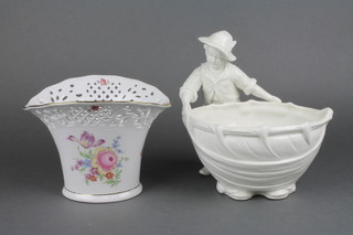 A 19th Century Continental white glazed centre piece in the form of a boy holding a basket 9", a Continental flattened oval vase decorated flowers