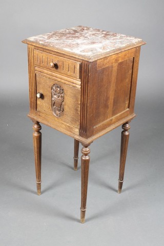 A 19th Century French carved oak bedside cabinet with veined marble top fitted a drawer above a cupboard, raised on turned and fluted supports 33"h x 15"w x 15"d 