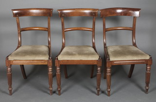 A set of 3 Georgian mahogany bar back dining chairs with plain mid rails and upholstered drop in seats, raised on turned and reeded supports  