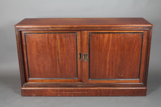 An Edwardian D shaped walnut cabinet enclosed by a sliding panelled door 34"h x 58 1/2"w x 18"d  