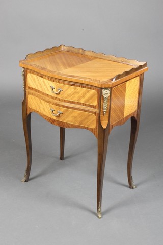 A 20th Century French Kingwood bedside table of serpentine outline, having a raised three-quarter gallery, fitted 2 long drawers, with gilt metal mounts, raised on cabriole supports 23"h x 18 1/2"w x 13 1/2"d 