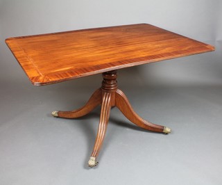 A rectangular 19th Century snap top breakfast table with crossbanded top, raised on a pillar and tripod base ending in brass paw casters 28 1/2"h x 52"w x 33"d 